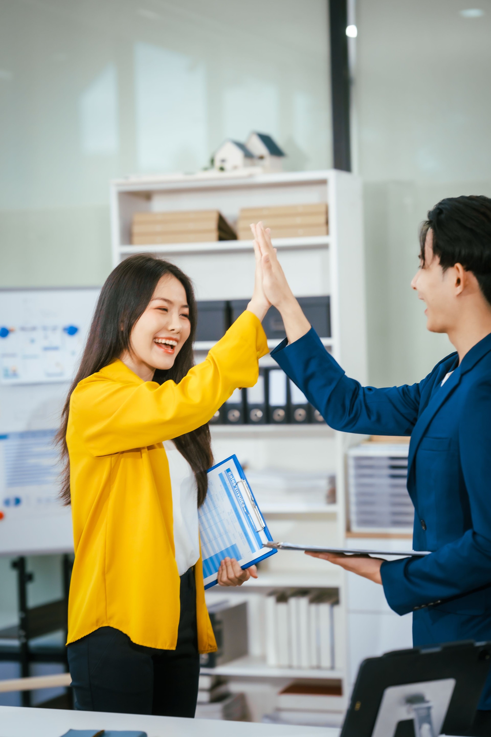 A businessman and businesswoman shake hands during a meeting at the office,signifying collaboration.They discuss strategies, agreements,opportunities to drive business growth strengthen professional